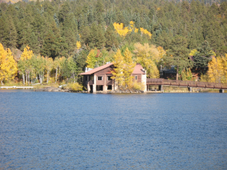 Historic Electra Sporting Club Building beside a lake in the early fall.