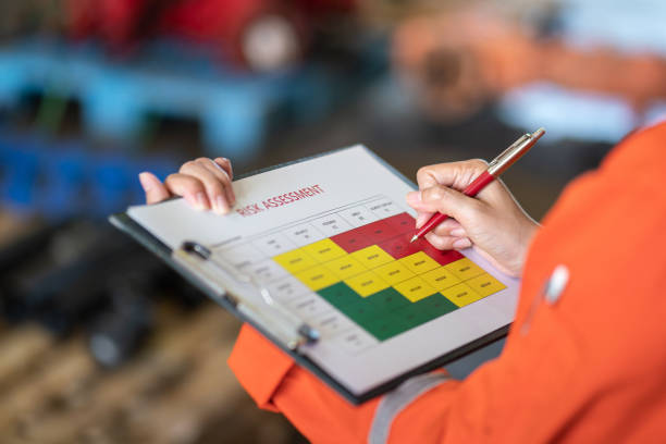 Person Recording Risk Results on a Clipboard